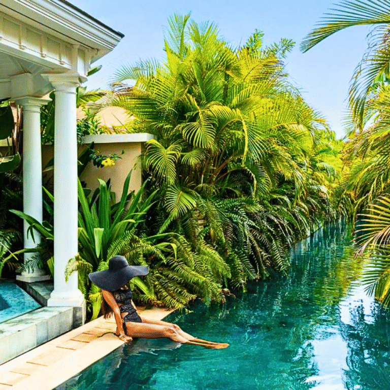 luxury hotel pool with palm trees and an elegant lady wearing a black hat